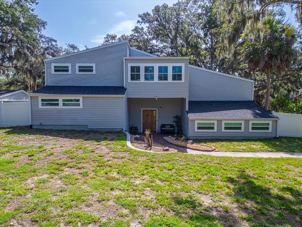 A two-story house with gray horizontal siding and a recessed front entrance — 11302 SANDPINE ROAD, RIVERVIEW, FL