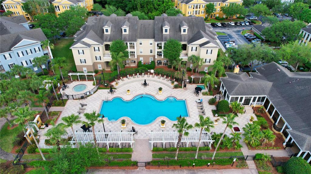 An aerial view shows a multi-story apartment building with a central swimming pool and patio — 3757 CONROY RD UNIT 2531, ORLANDO, FL