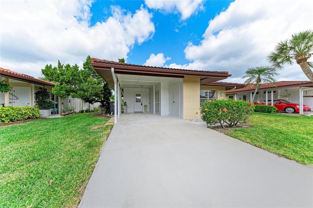 A single-story home with a concrete driveway, a covered carport, and a green lawn — 3303 CHICAGO AVENUE, BRADENTON, FL
