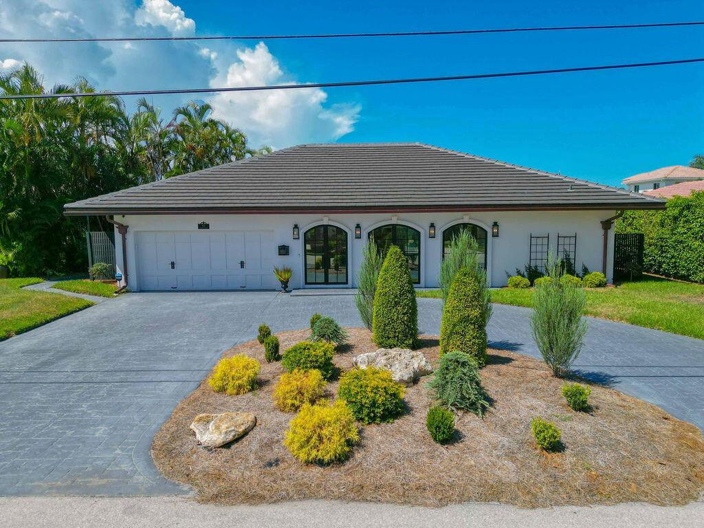 A single-story house with a white exterior, a two-car garage, and a landscaped front yard — 713 Forsyth Street, Boca Raton FL 33487, BOCA RATON, FL