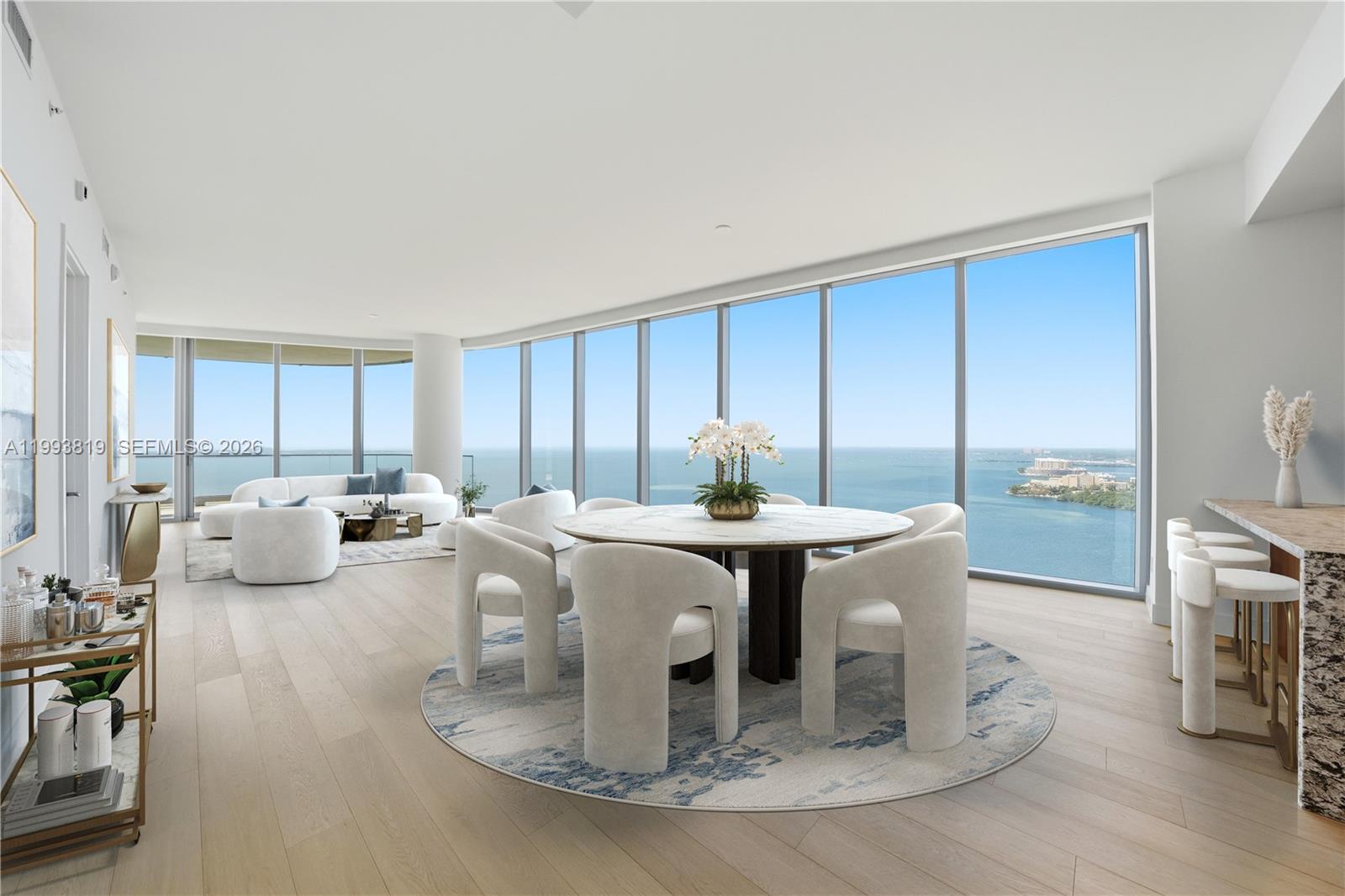 This modern open-concept living and dining area features floor-to-ceiling windows with expansive ocean views — 175 SE 25th Road # 3102, Miami FL 33129, MIAMI, FL