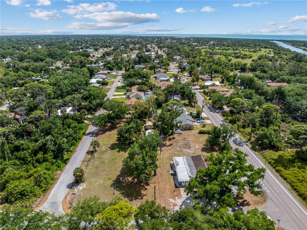 An aerial view shows a residential lot with a small building between two paved roads — DAWN DRIVE, VENICE, FL