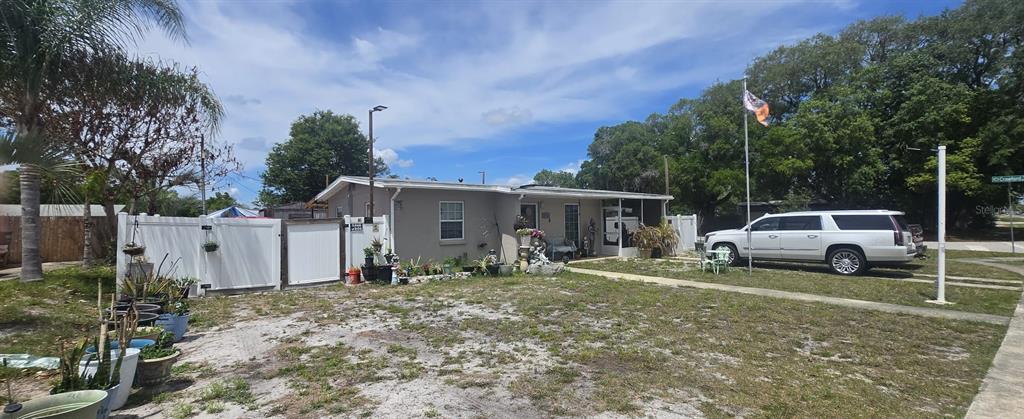 A single-story house with a white fence, a parked SUV, and a flag pole outside — 1222 STILLWATER AVENUE, DELTONA, FL