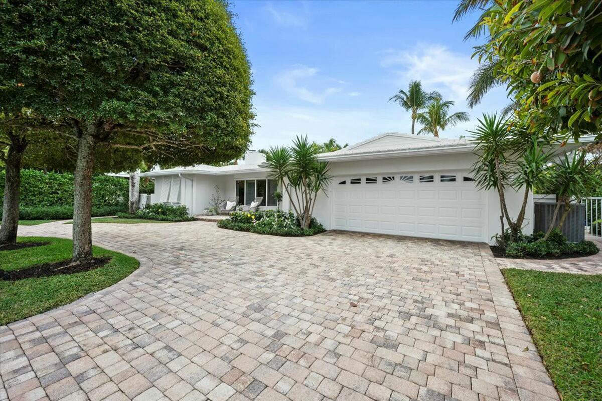A white single-story house features a large paver driveway and a two-car garage — 232 Cove Place, Jupiter FL 33469, JUPITER, FL