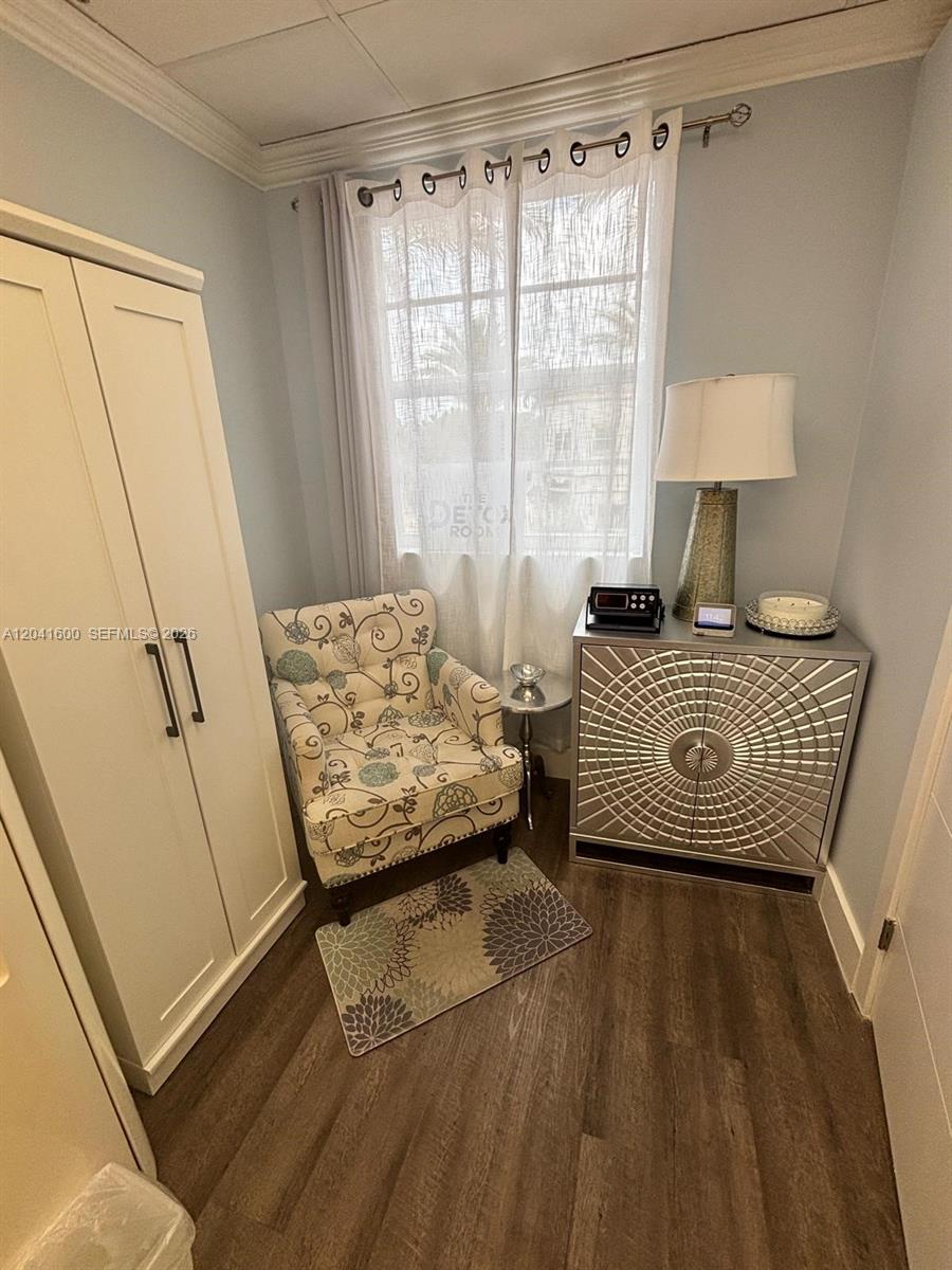 A small room features a patterned armchair, a silver cabinet, and a white wardrobe — WESTON, FL