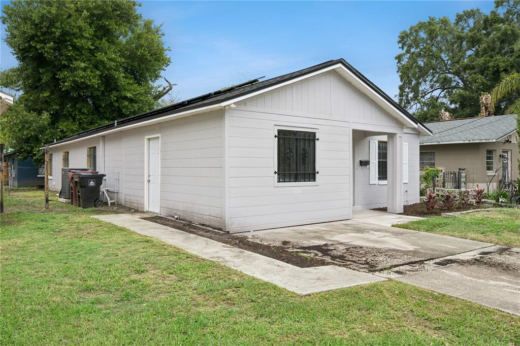 A light gray single-story house with a concrete driveway and a small front porch — 716 GROVE AVENUE, ORLANDO, FL