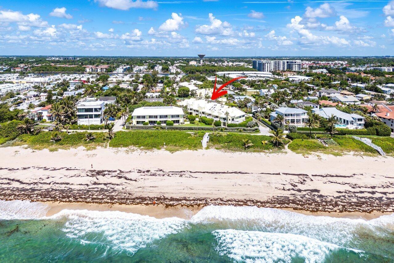 An aerial view of a beachfront residential complex with a red arrow pointing toward it — 5109 N Ocean E Boulevard, Ocean Ridge FL 33435, OCEAN RIDGE, FL