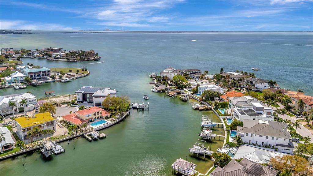 An aerial view shows waterfront luxury homes along a canal leading into a large bay — 2618 S DUNDEE STREET UNIT PARCEL A, TAMPA, FL