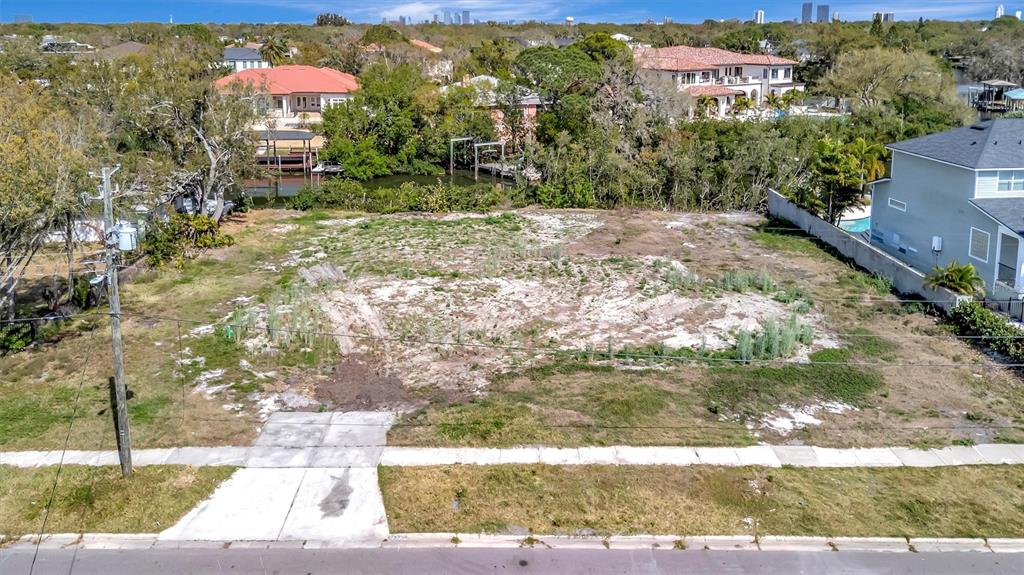 An aerial view shows a vacant, grassy residential lot with a concrete driveway apron — 2618 S DUNDEE STREET UNIT PARCEL A, TAMPA, FL