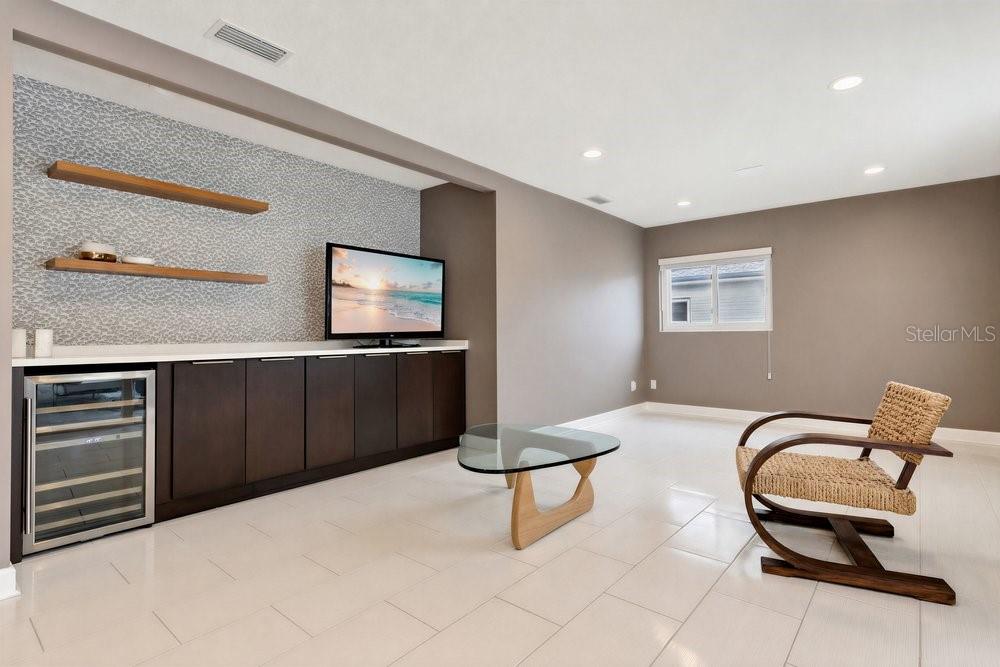 A modern living room features a wet bar with a wine cooler and floating shelves — 514 BAKER STREET, ORLANDO, FL