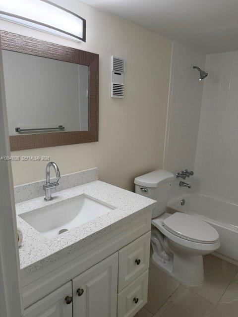 A bathroom features a white vanity with a speckled countertop, a mirror, and a tub-shower — 8405 NW 8th St # 303, Miami FL 33126, MIAMI, FL