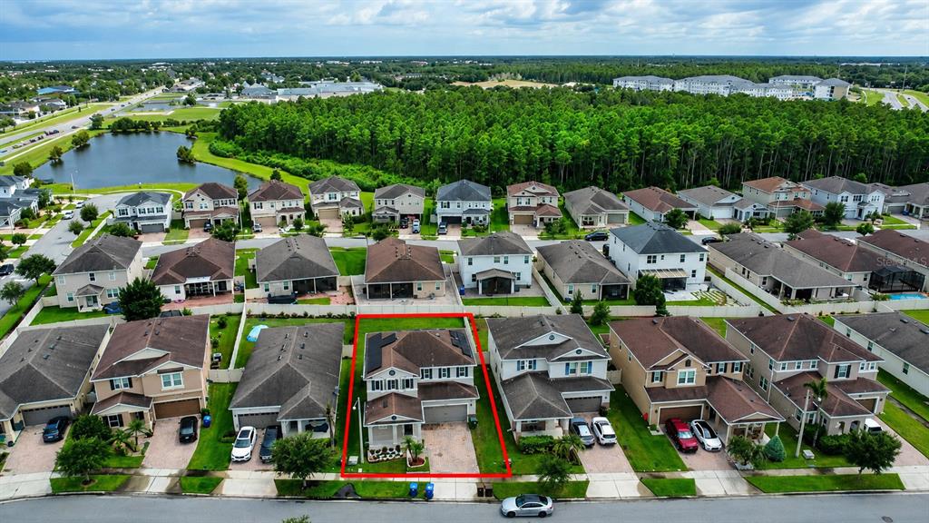 An aerial view shows a two-story suburban house outlined in red within a residential neighborhood — 3430 CANVAS STREET, KISSIMMEE, FL