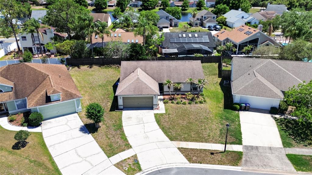 An aerial view shows a suburban house with a brown roof and concrete driveway — 861 BLACKGUM COURT, ORLANDO, FL