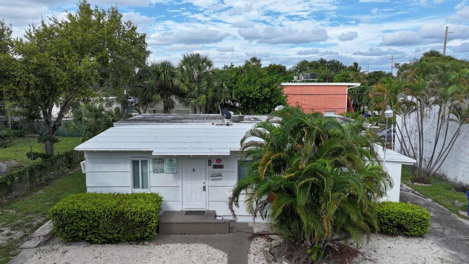A white, single-story building with a flat roof, a front door, and a palm tree — 211 SW 2nd Court, Pompano Beach FL 33060, POMPANO BEACH, FL