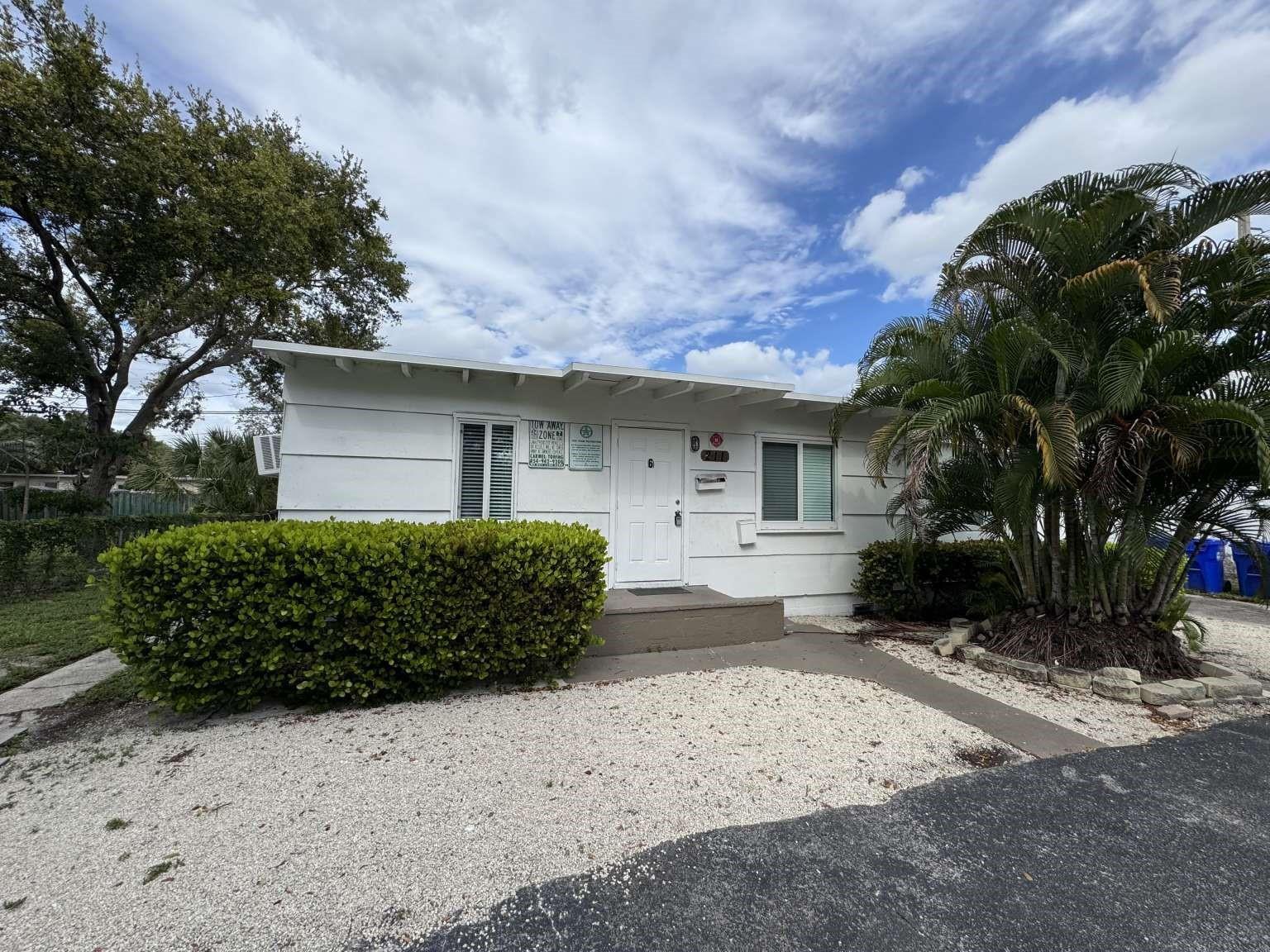 A single-story white house with a gravel front yard, a hedge, and a palm tree — 211 SW 2nd Court, Pompano Beach FL 33060, POMPANO BEACH, FL