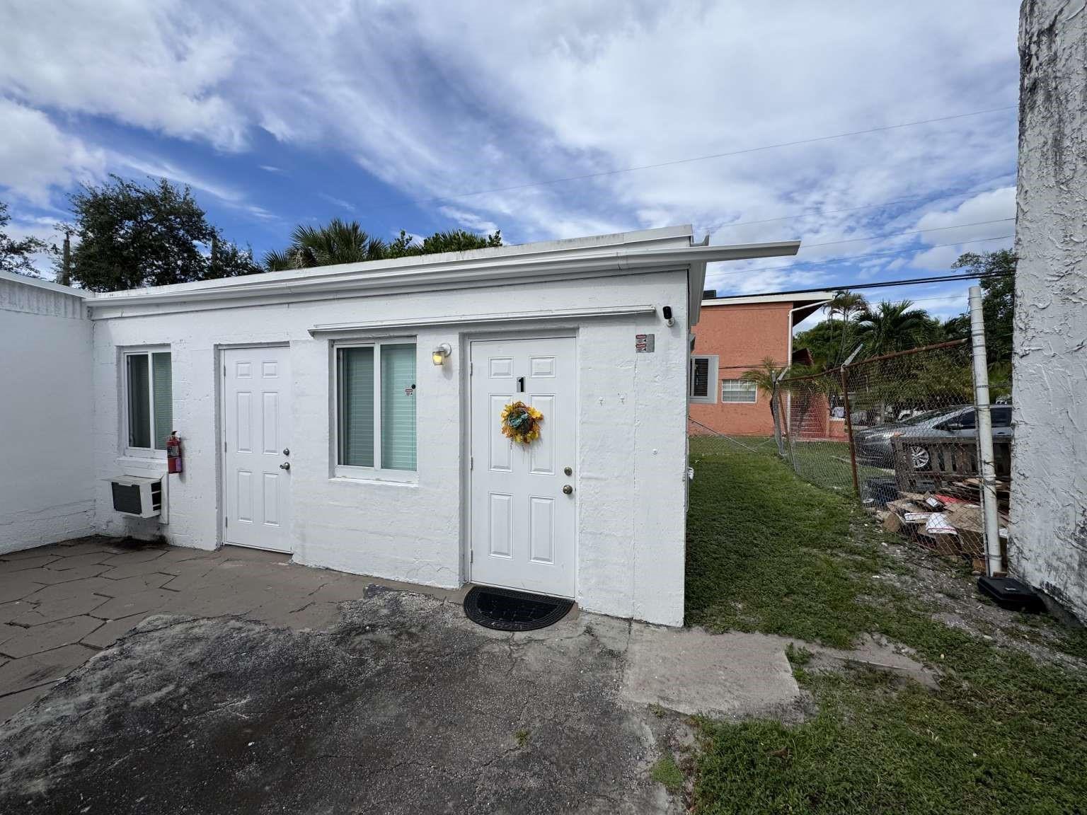 Exterior view of a small white building with two doors and a window — 211 SW 2nd Court, Pompano Beach FL 33060, POMPANO BEACH, FL