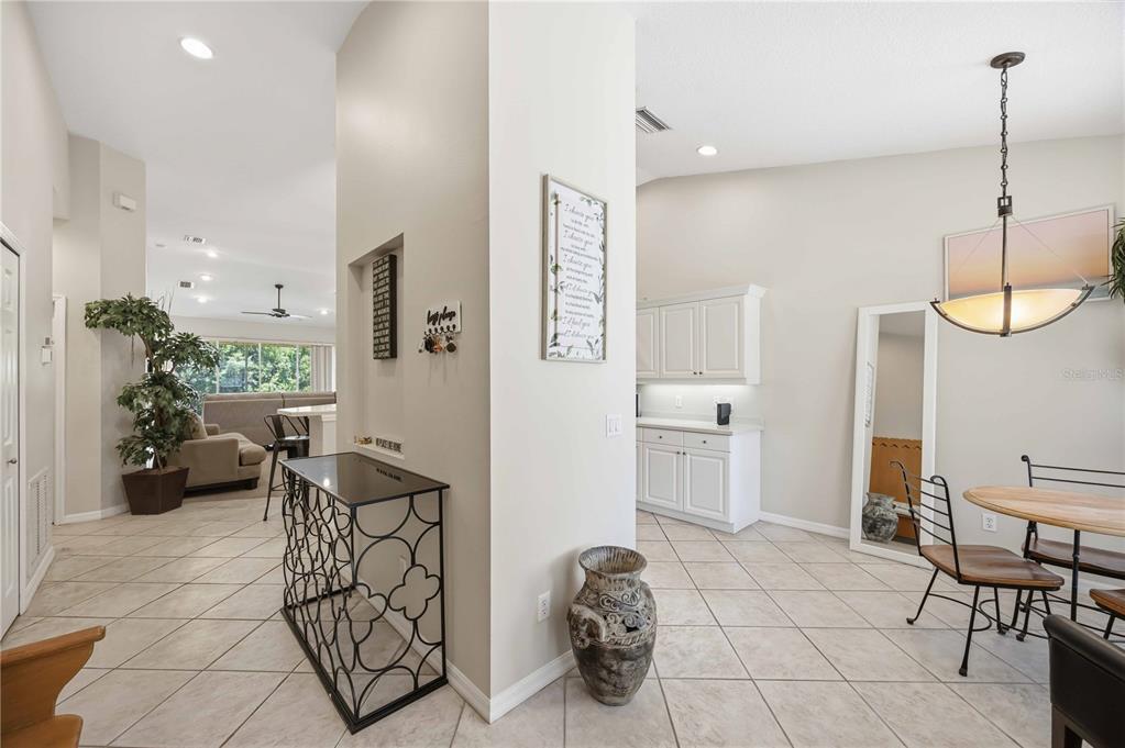 A dining area with tile floors, a white cabinet unit, and a metal console table — 5629 KEY LARGO COURT UNIT B06, BRADENTON, FL