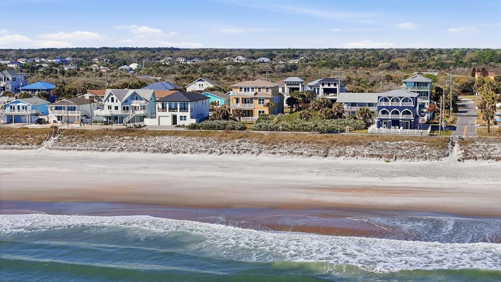 An aerial view shows a row of beachfront houses along a sandy coastline — 2208 S OCEAN SHORE BOULEVARD, FLAGLER BEACH, FL