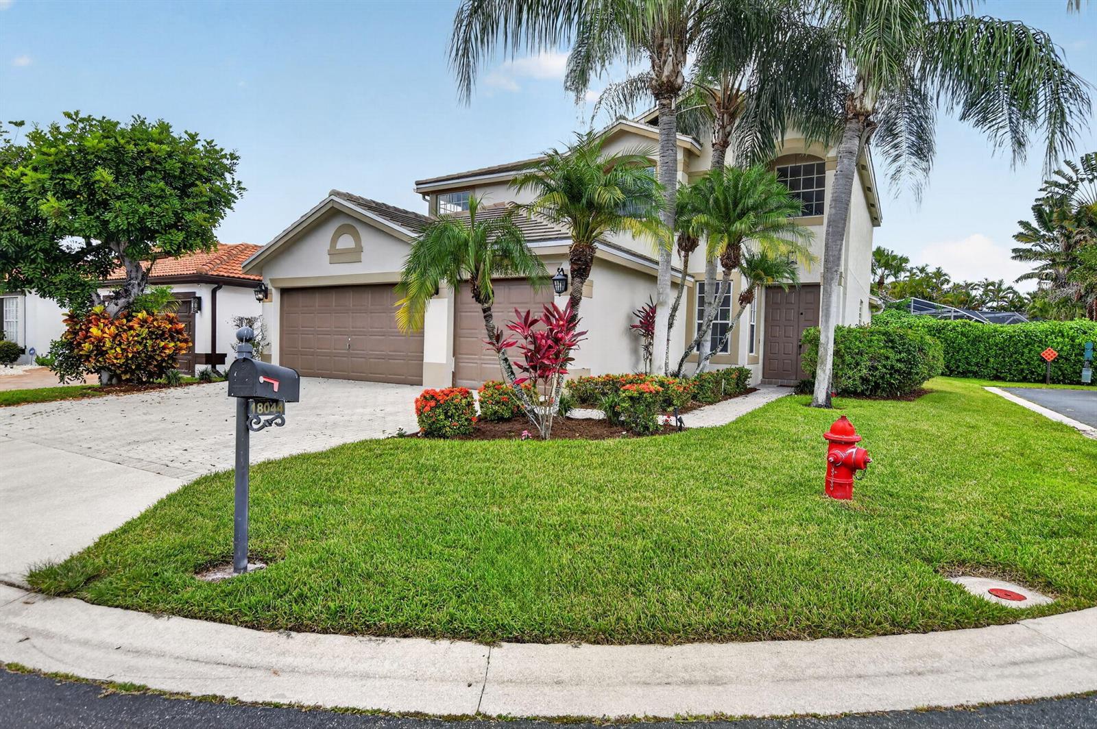 A two-story suburban house features a two-car garage, palm trees, and a front lawn — 18044 Jazz Lane, Boca Raton FL 33496, BOCA RATON, FL