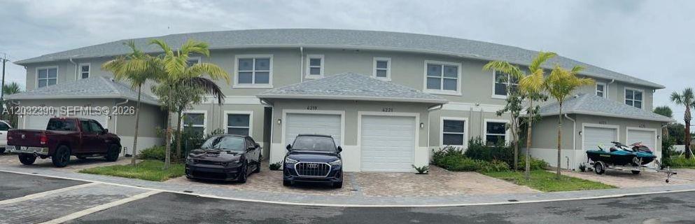 A multi-unit residential building with light-colored siding, gray roofs, and paved driveways — 4217 Gulfstream Rd, Lake Worth FL 33461, LAKE WORTH, FL
