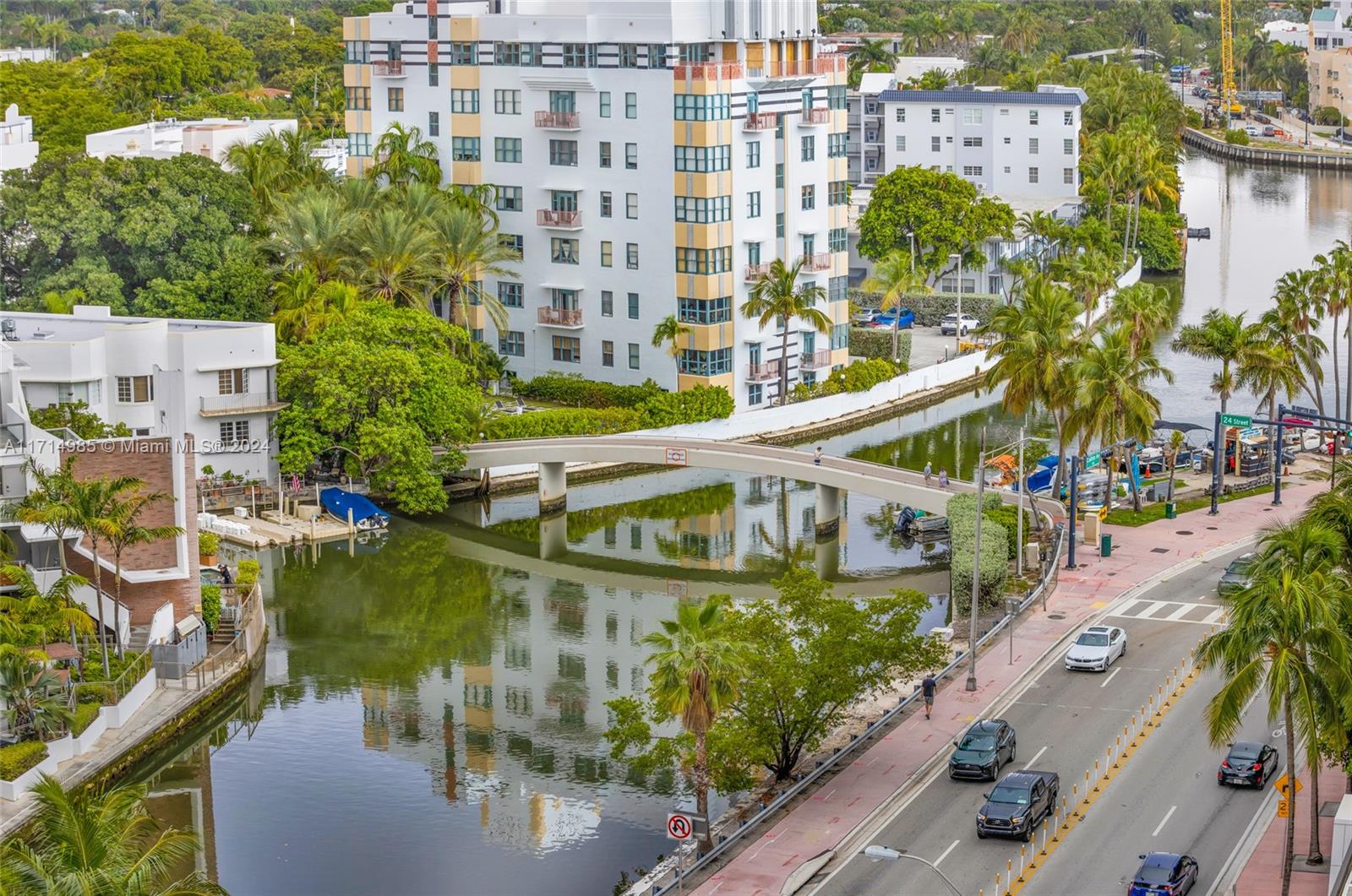 An elevated view shows a pedestrian bridge crossing a canal next to a multi-story building — 2301 Collins Ave # 1030, Miami Beach FL 33139, MIAMI BEACH, FL
