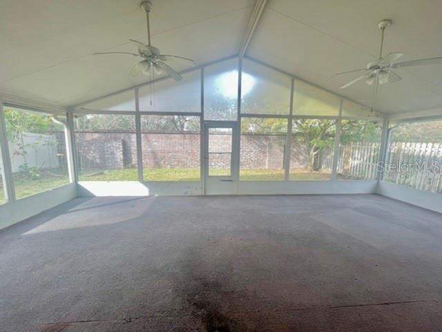 A screened-in patio with a concrete floor, two ceiling fans, and a view of a yard — 2861 FALLING TREE CIRCLE, ORLANDO, FL