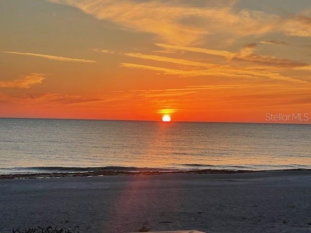 A sunset view over the ocean with a sandy beach in the foreground — 5757 GULF OF MEXICO DRIVE UNIT 202, LONGBOAT KEY, FL