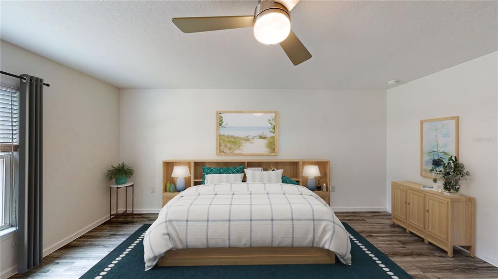 A bedroom features a bed with a wooden headboard, a ceiling fan, and wood flooring — 3438 ALWOOD STREET, NORTH PORT, FL