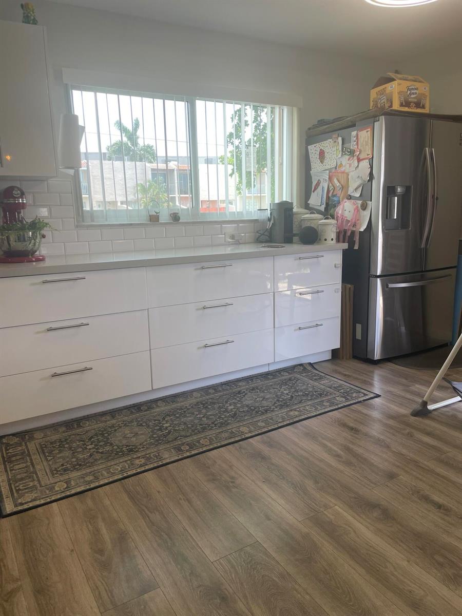 A kitchen features white flat-panel cabinets, a subway tile backsplash, and a stainless steel refrigerator — 3650 SW 59th Terrace # 80, Davie FL 33314, DAVIE, FL