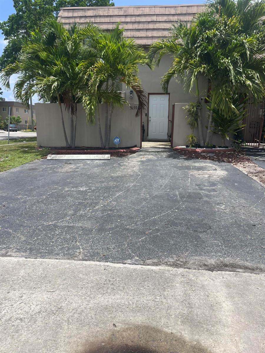 A paved driveway leads to a house entrance framed by palm trees and a wall — 3650 SW 59th Terrace # 80, Davie FL 33314, DAVIE, FL