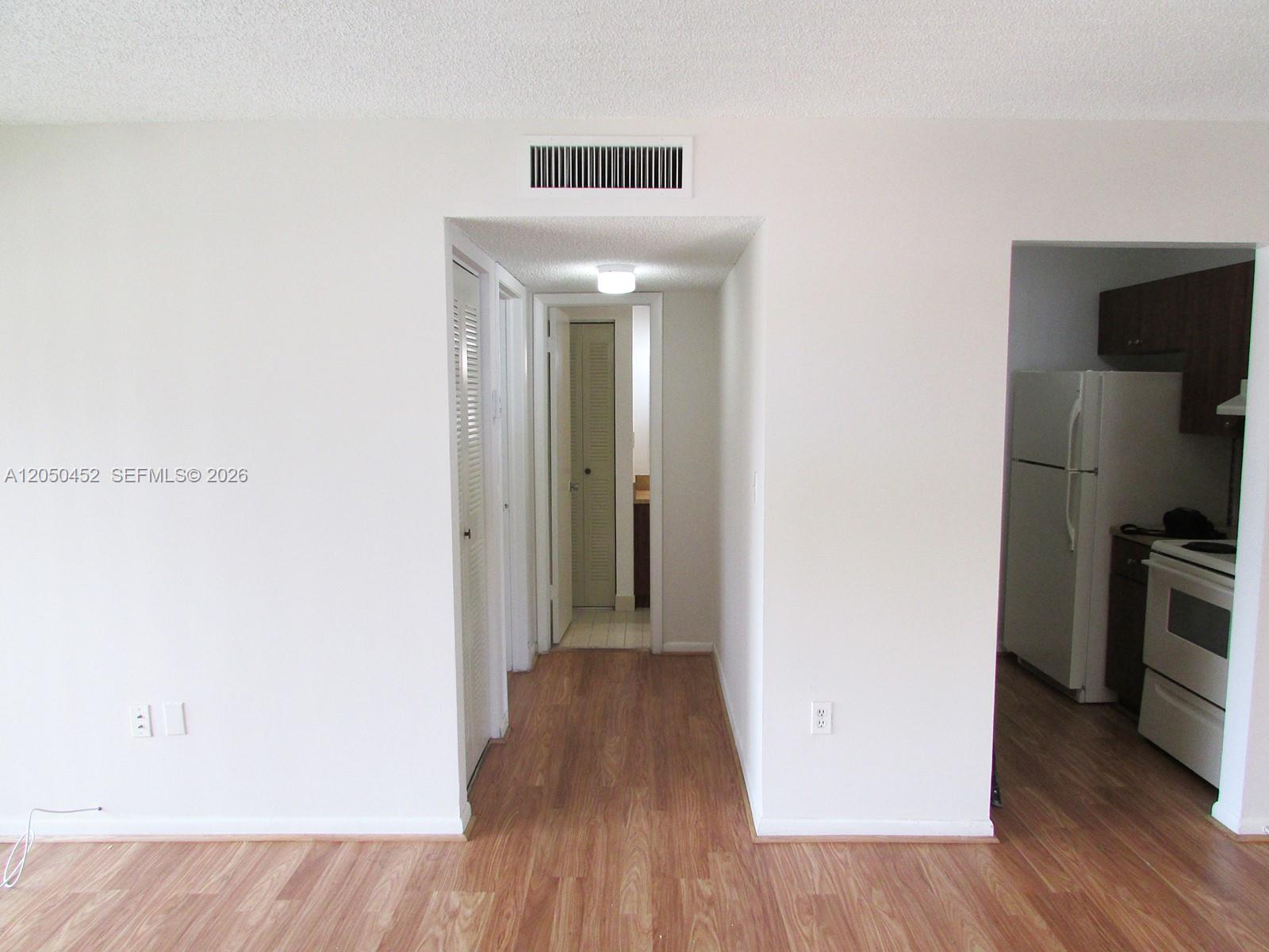 A view from a living area looking into a hallway and a kitchen — 7407 SW 152nd Ave # 204, Miami FL 33193, MIAMI, FL