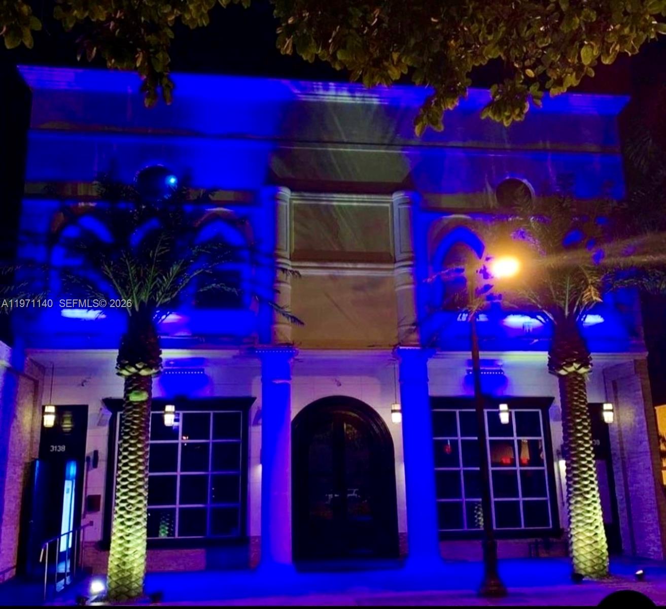 The exterior of a building at night is illuminated with bright blue accent lighting — 3138 Coral Way, Miami FL 33145, MIAMI, FL