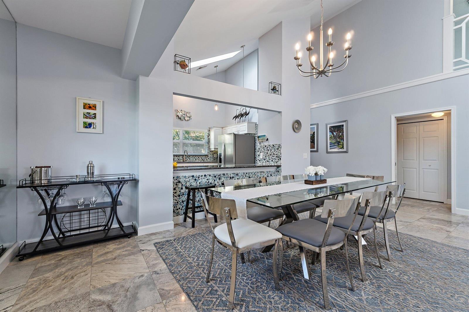 A dining room with a glass table, metal chairs, and a view into the kitchen — 4161 S. Us Highway 1 # G3, Jupiter FL 33477, JUPITER, FL