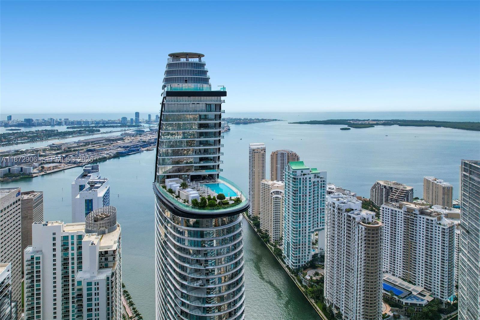 This image shows an aerial view of a high-rise building and its floor plan — 300 Biscayne Blvd Way, Miami FL 33131, MIAMI, FL