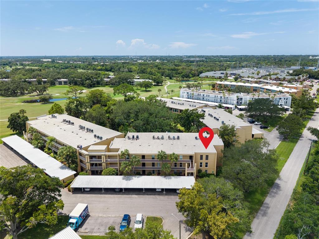 An aerial view shows a multi-story apartment building with a red location marker — 225 COUNTRY CLUB DRIVE UNIT E343, LARGO, FL