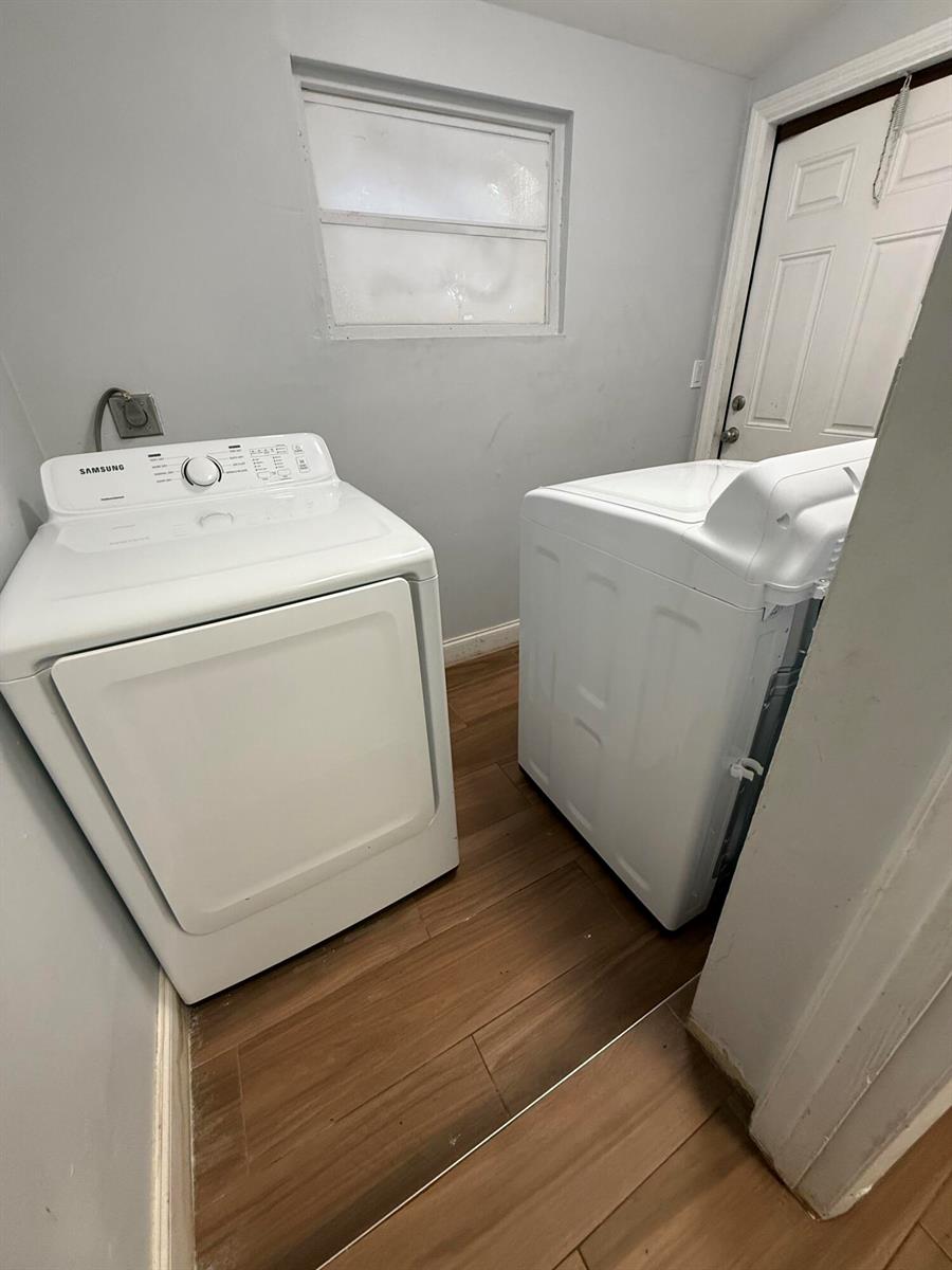 A laundry room features a white dryer, a white top-load washer, and wood-look flooring — 1503 N J Street # A, FL 33460, FL