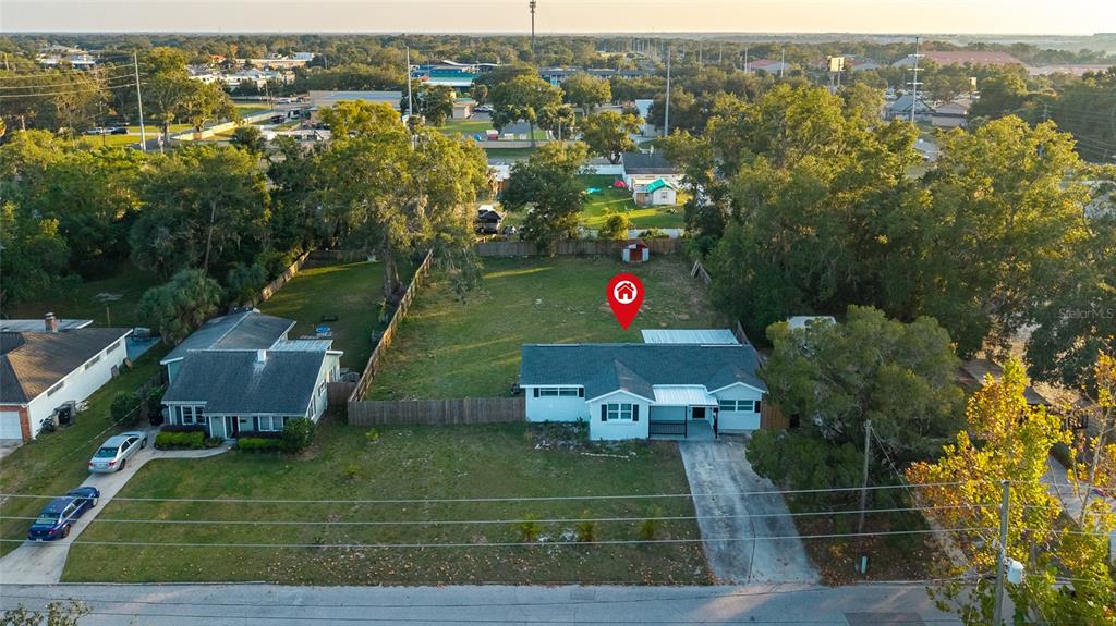 An aerial view shows a single-story house with a large backyard and a detached shed — 234 W MAGNOLIA STREET, APOPKA, FL