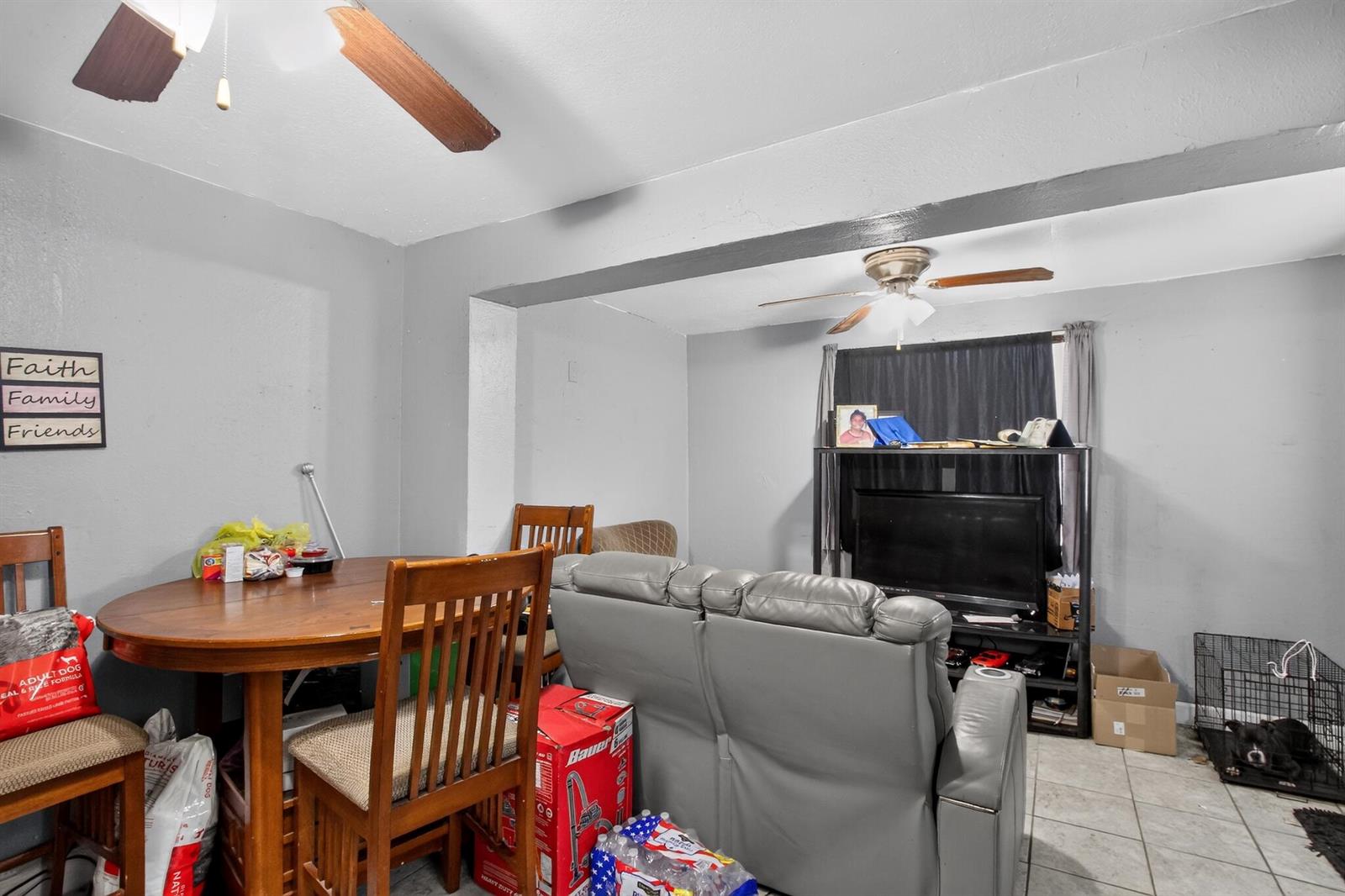 A living and dining area features a grey sofa, wooden table, and two ceiling fans — 608 NW 15th Avenue, Pompano Beach FL 33069, POMPANO BEACH, FL