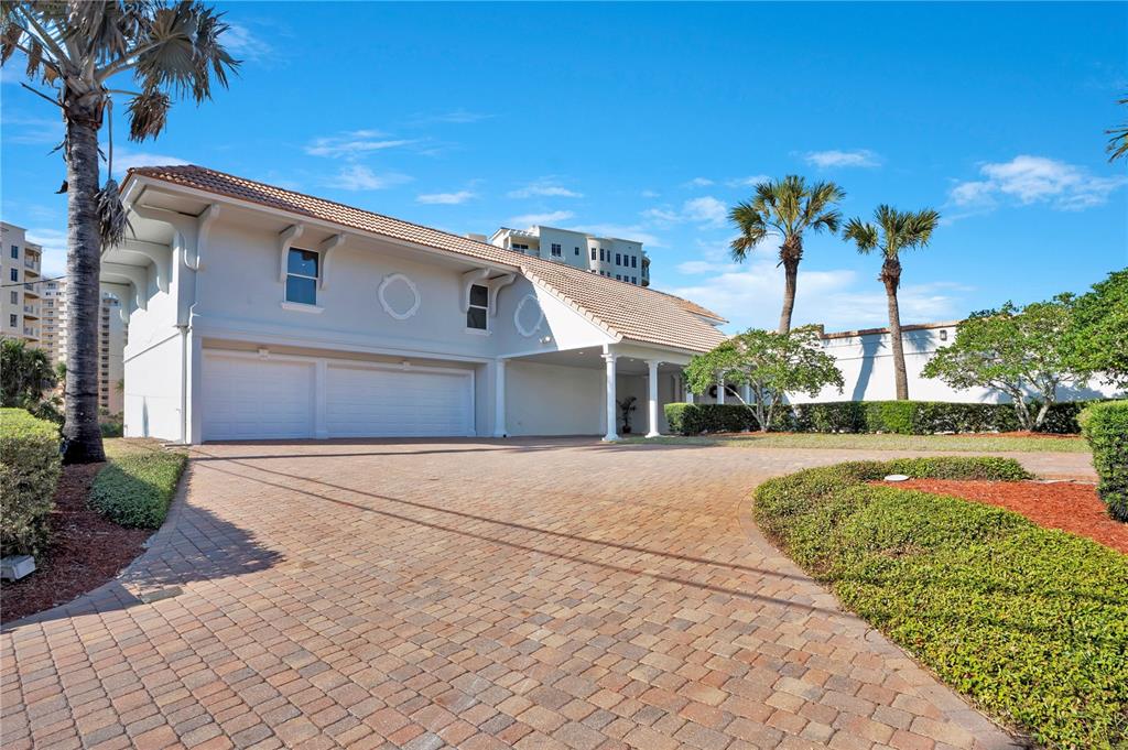 A paved driveway leads to a two-car garage and a covered entryway of a house — 2117 OCEAN DRIVE, NEW SMYRNA BEACH, FL