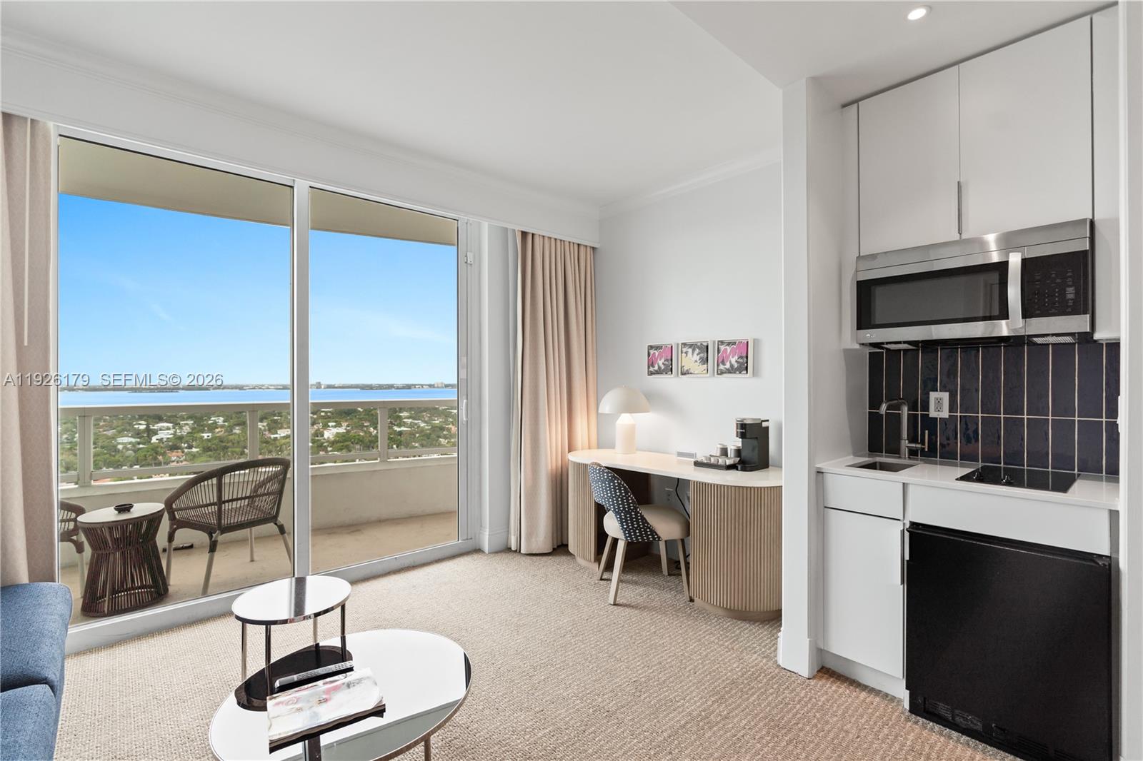 A hotel room features a kitchenette, a desk, and a balcony overlooking the ocean — 4401 Collins Ave # 2517, Miami Beach FL 33140, MIAMI BEACH, FL