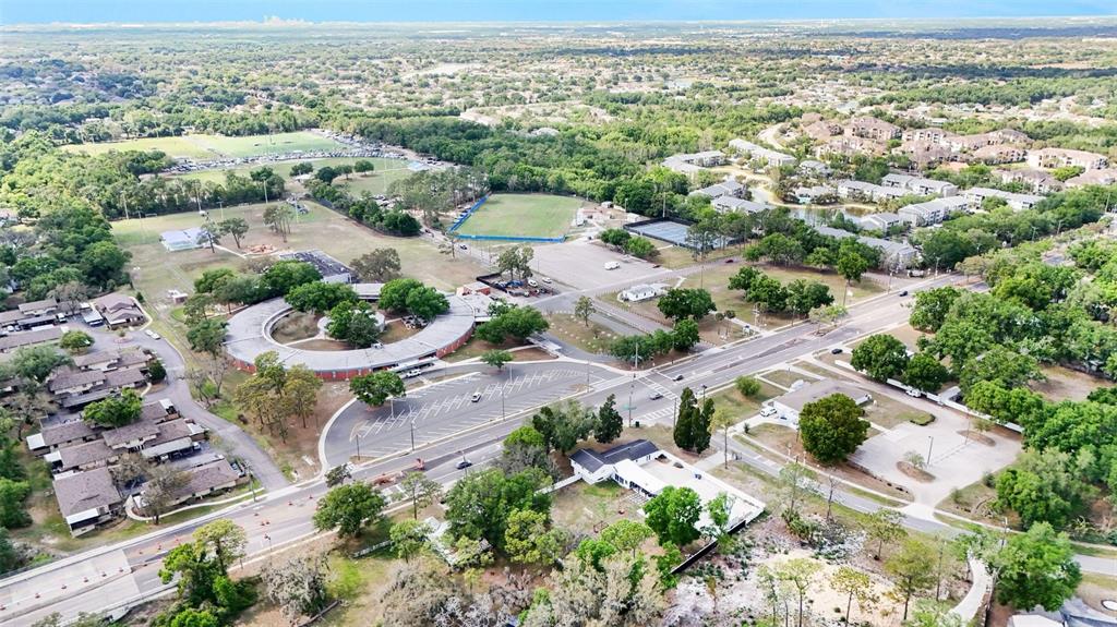 An aerial view shows a circular building, parking lots, sports fields, and surrounding residential areas — 3101 S KINGS AVENUE, BRANDON, FL
