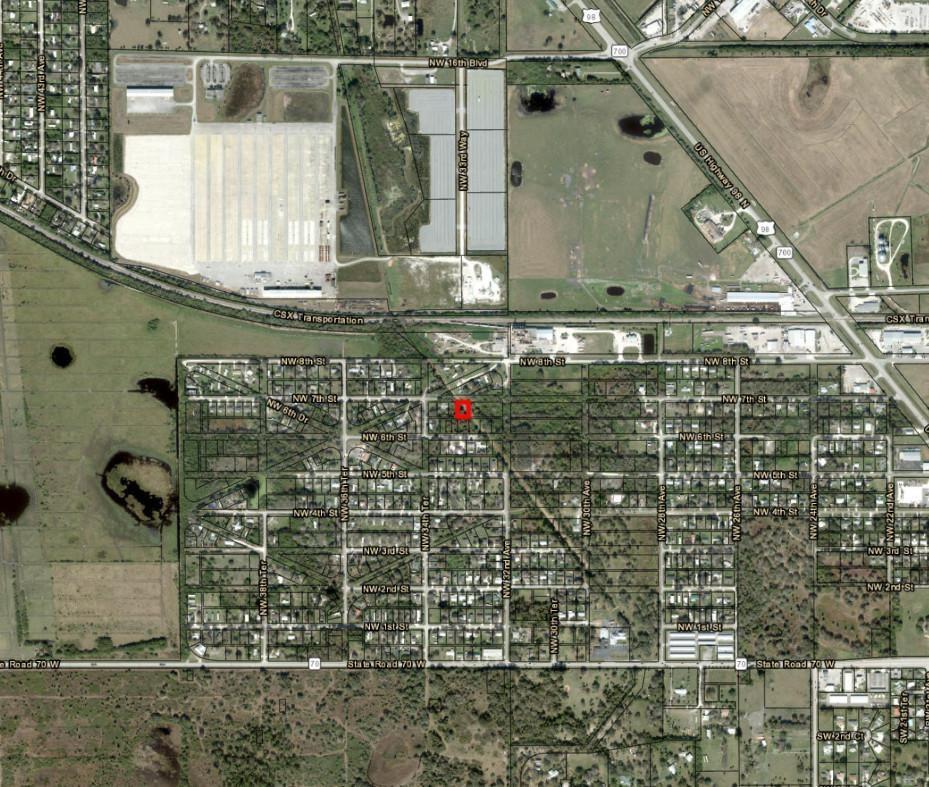 An aerial map view showing a residential neighborhood with a red marker indicating a property — 3252 NW 7th Street, Okeechobee FL 34972, OKEECHOBEE, FL
