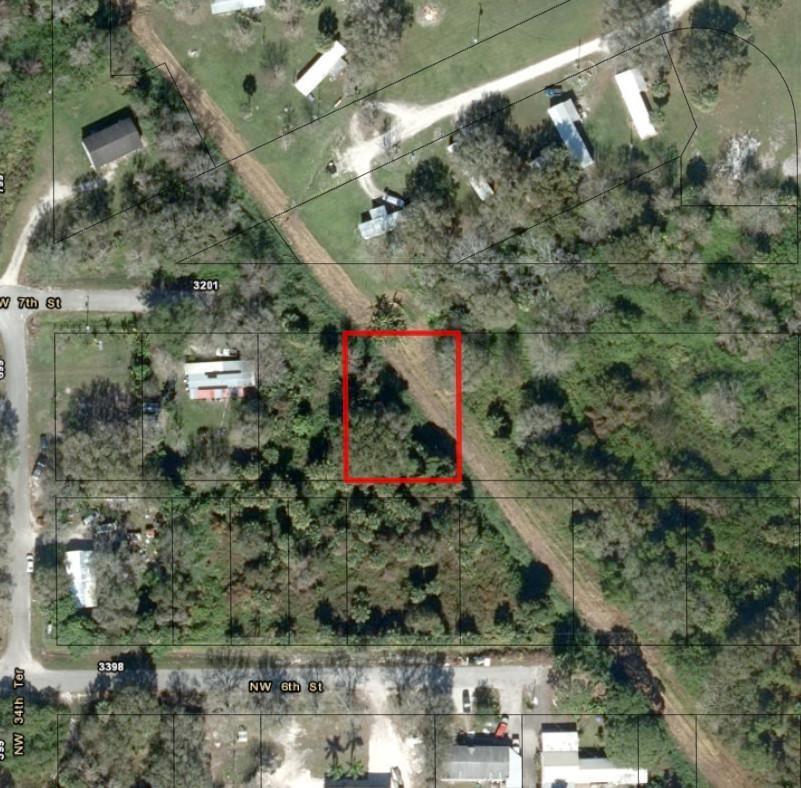 An aerial map view shows a rectangular lot highlighted in red amidst wooded residential land — 3252 NW 7th Street, Okeechobee FL 34972, OKEECHOBEE, FL