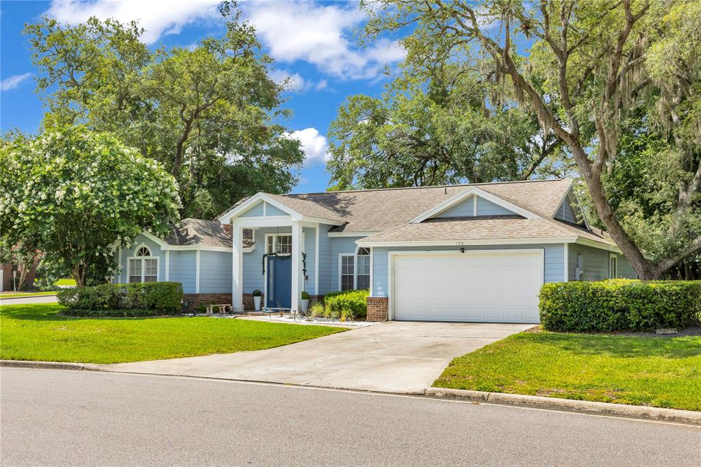 A light blue single-story house with a white garage and a covered front entryway — 170 OAK VIEW CIRCLE, LAKE MARY, FL