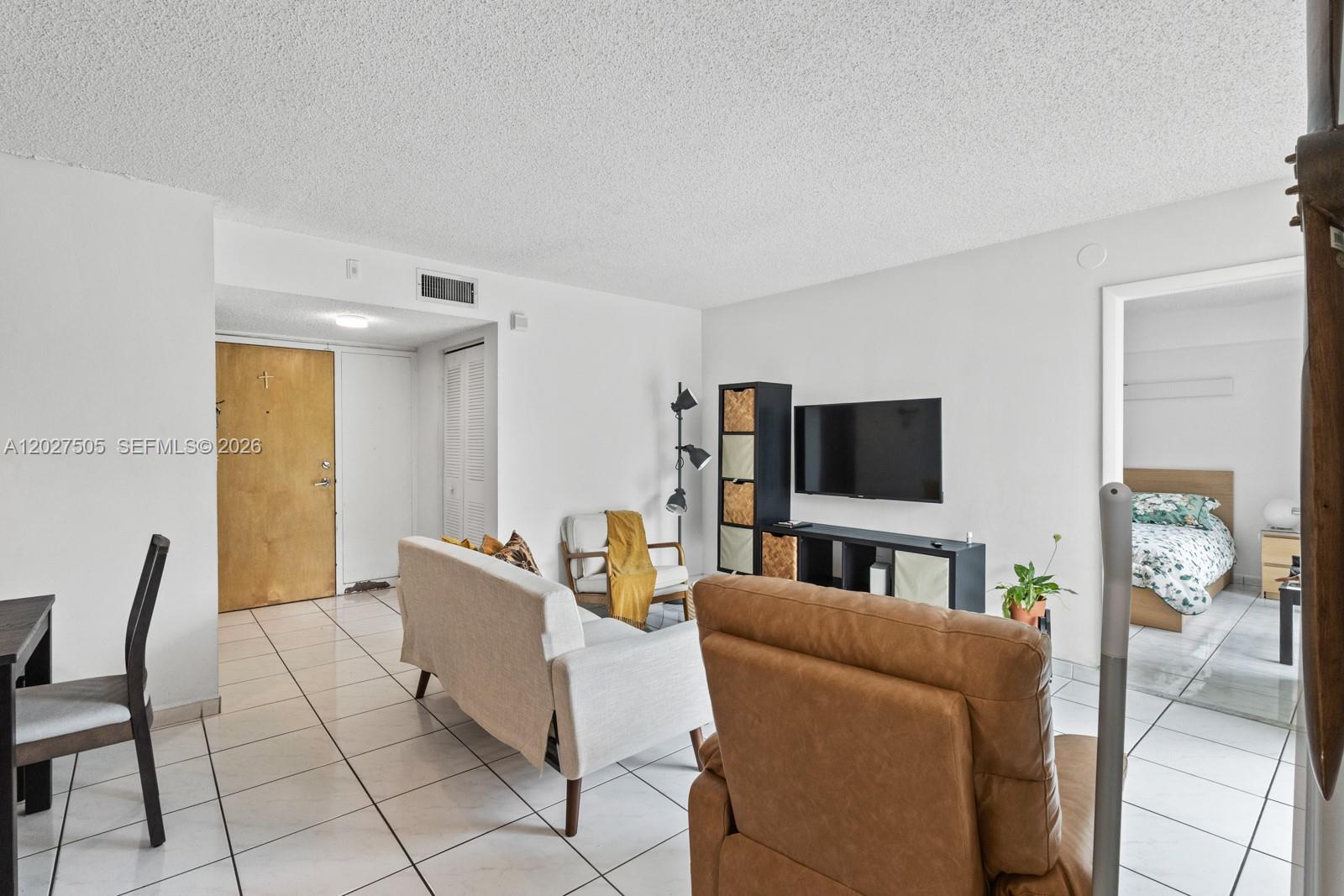A living room features white tile floors, a television, and a brown leather recliner — 2075 SW 122nd Ave # 226, Miami FL 33175, MIAMI, FL