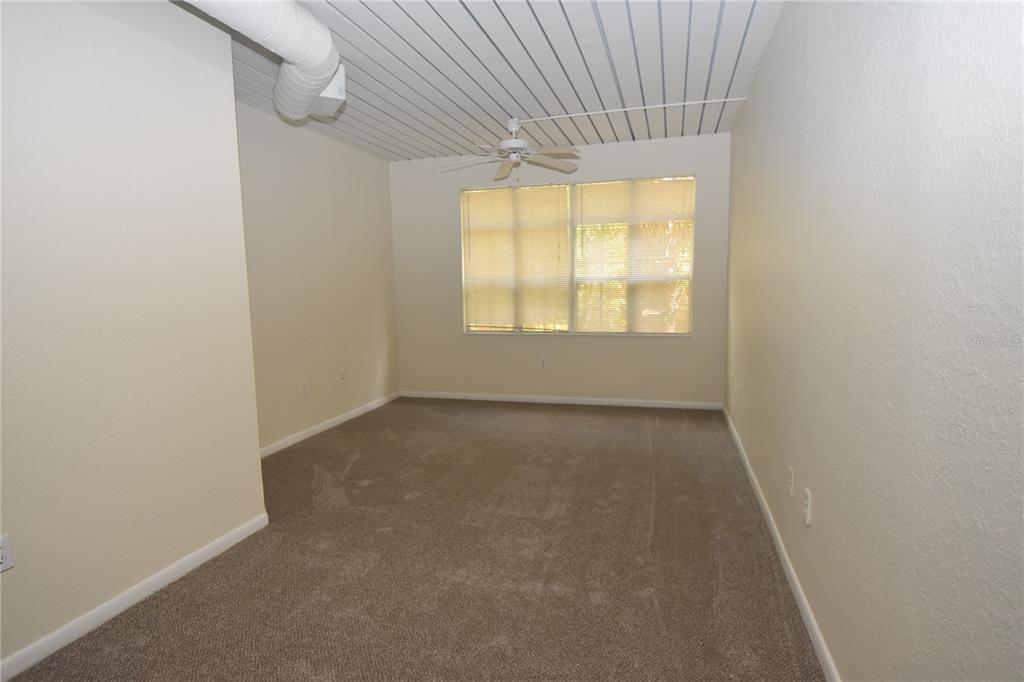 An empty bedroom features beige carpet, white walls, a ceiling fan, and a slatted ceiling — 2402 W AZEELE STREET UNIT 426, TAMPA, FL