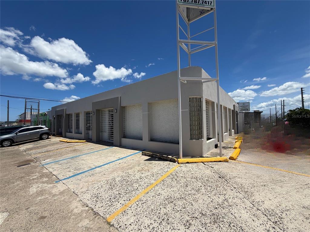 A single-story commercial building with a metal sign frame and a concrete parking lot — Z40 LAUREL AVENUE, BAYAMON, PR