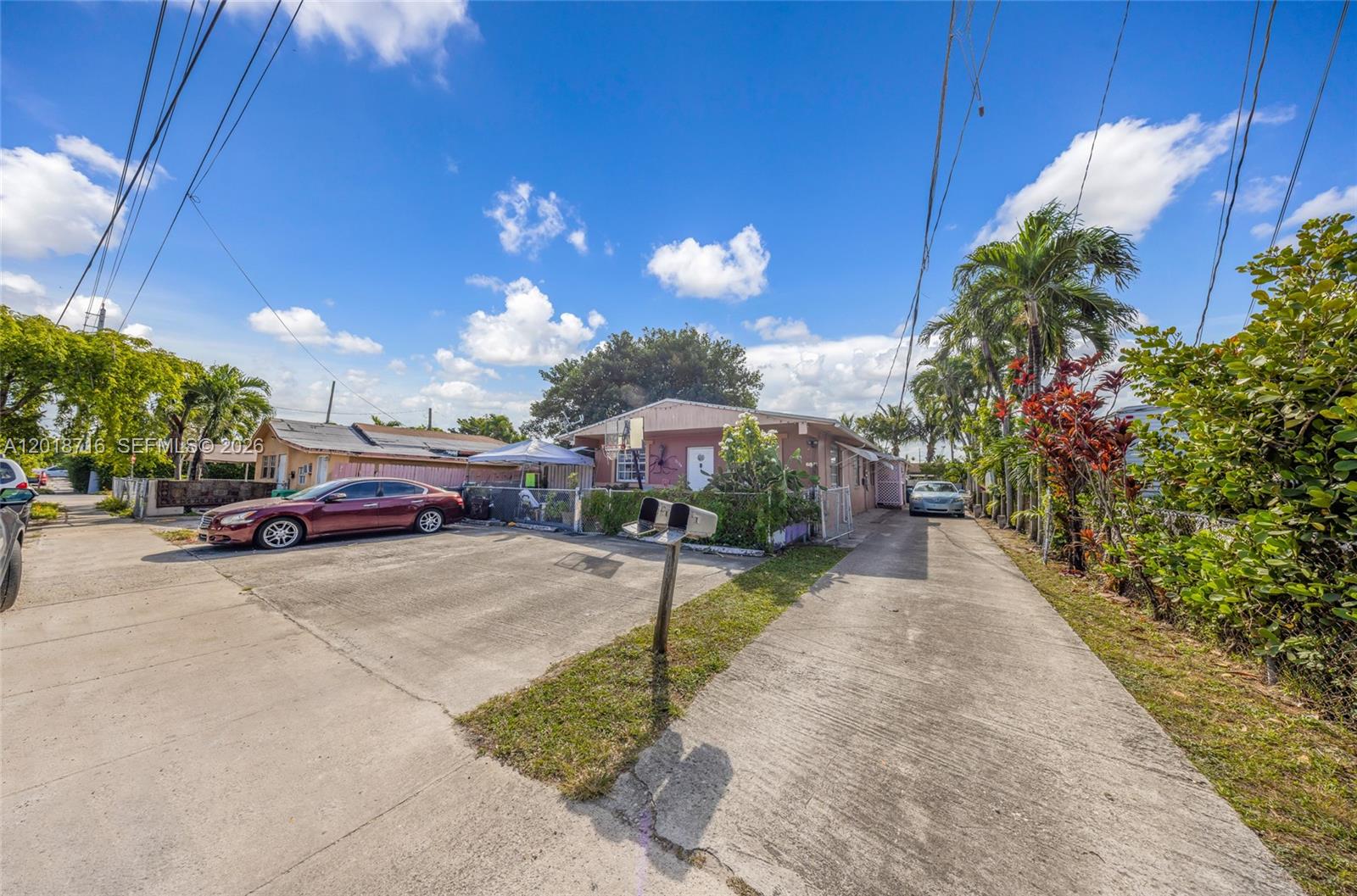 A single-story house with a concrete driveway, a parked car, and a mailbox — 3126 NW 28th St, Miami FL 33142, MIAMI, FL