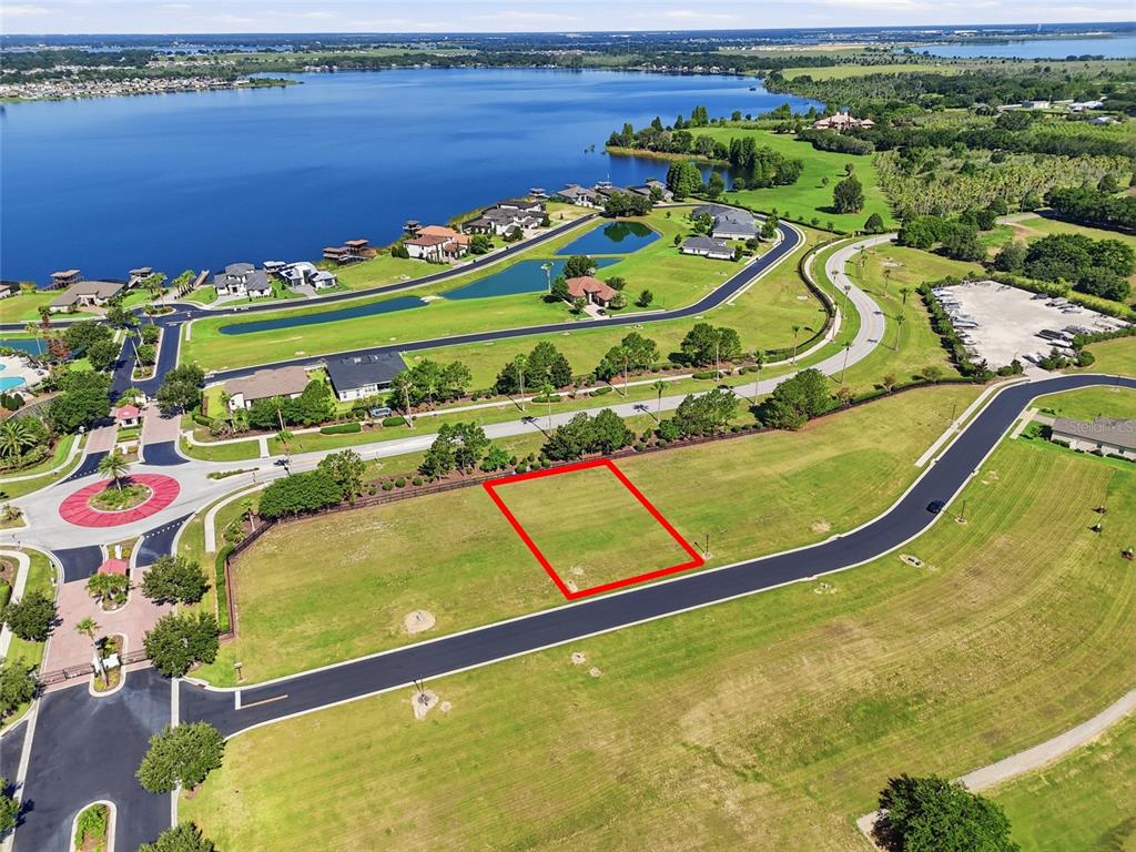 An aerial view shows a vacant rectangular residential lot outlined in red within a neighborhood — 500 BONAMIA AVENUE, LAKE ALFRED, FL