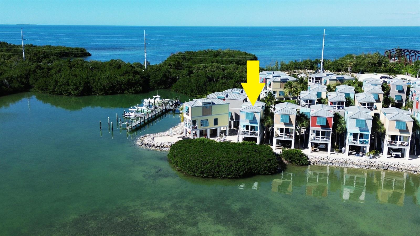 An aerial view shows a row of colorful waterfront houses with a private boat dock — 101 11th Street # 35, Marathon FL 33050, MARATHON, FL